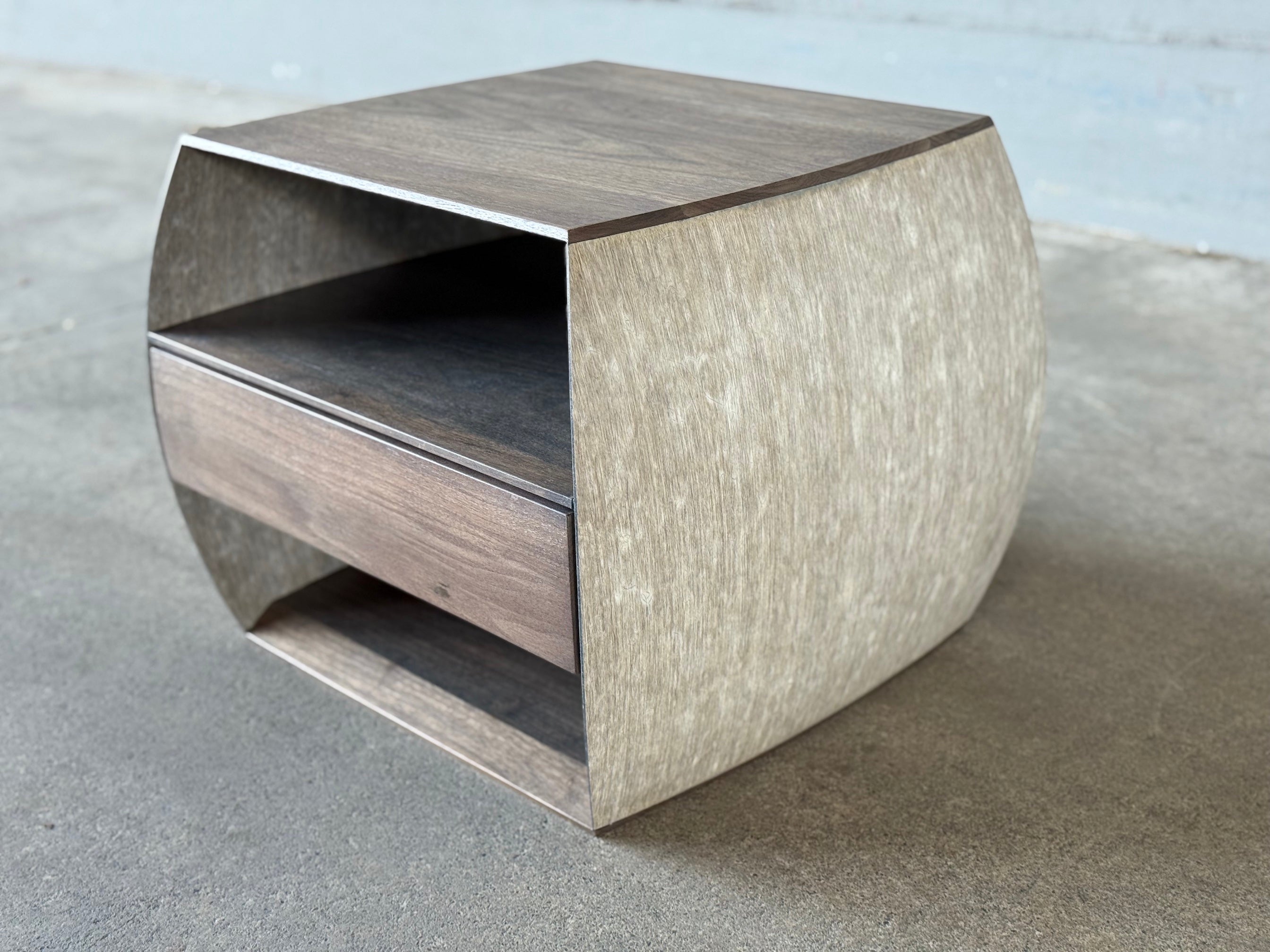 15" cube bedside table with softly curving flax composite sides, solid hardwood top and bottom.